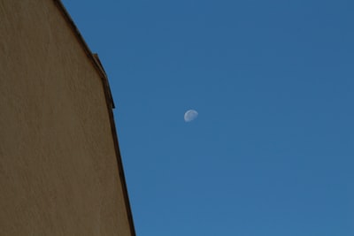 white moon on brown concrete wall